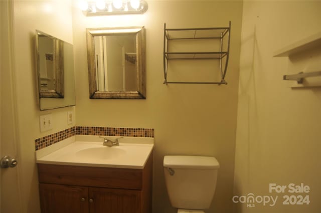 bathroom with toilet and vanity