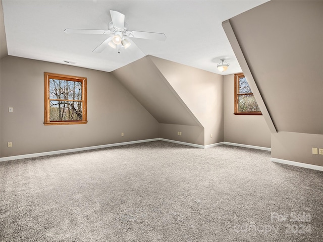 additional living space featuring lofted ceiling, carpet floors, and ceiling fan