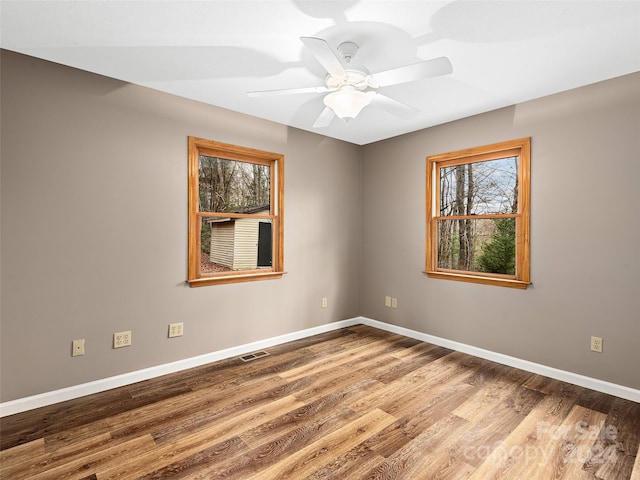 unfurnished room with wood-type flooring and ceiling fan