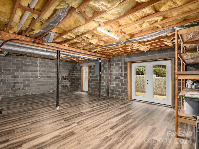 basement featuring wood-type flooring and french doors