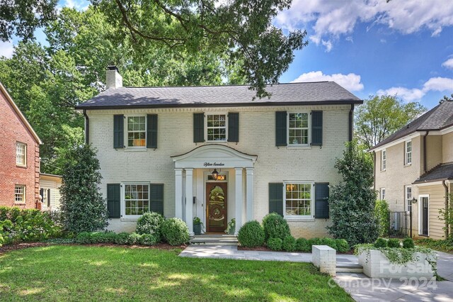 colonial home with a front yard