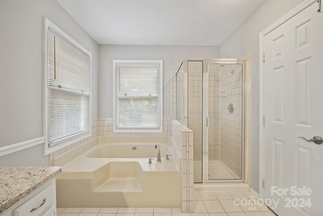 bathroom featuring vanity, tile patterned floors, and separate shower and tub