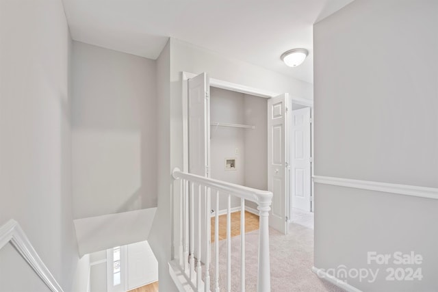 hallway with light colored carpet