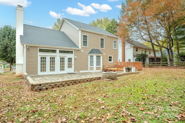 back of house featuring a yard, french doors, and a deck