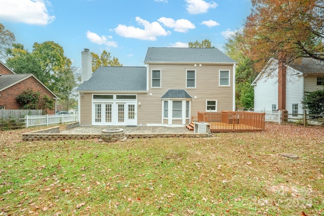 back of house featuring french doors, a yard, and a deck