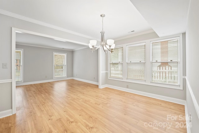 unfurnished dining area with ornamental molding, light hardwood / wood-style flooring, and a notable chandelier