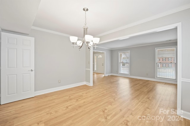 unfurnished room with light hardwood / wood-style floors, a notable chandelier, and crown molding