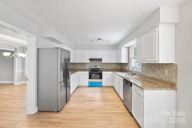 kitchen with white cabinetry, light wood-type flooring, appliances with stainless steel finishes, and sink