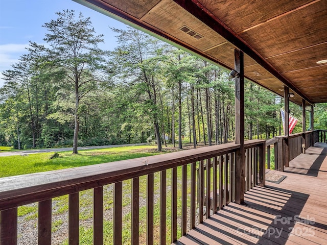 wooden terrace with a porch and a yard