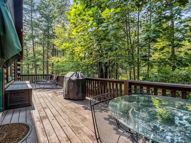 wooden deck with a grill