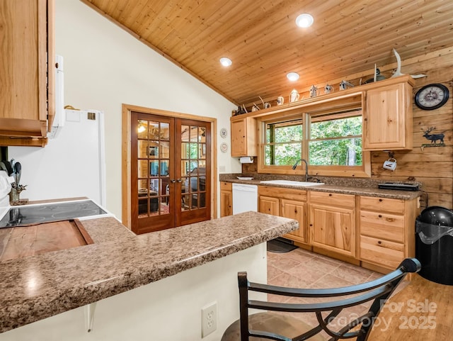 kitchen featuring french doors, light brown cabinetry, sink, dishwasher, and lofted ceiling