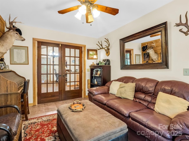 living room with french doors, light tile patterned floors, and ceiling fan