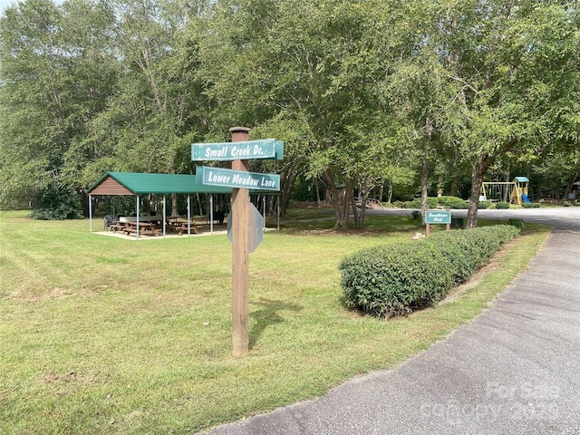 surrounding community featuring a playground and a yard