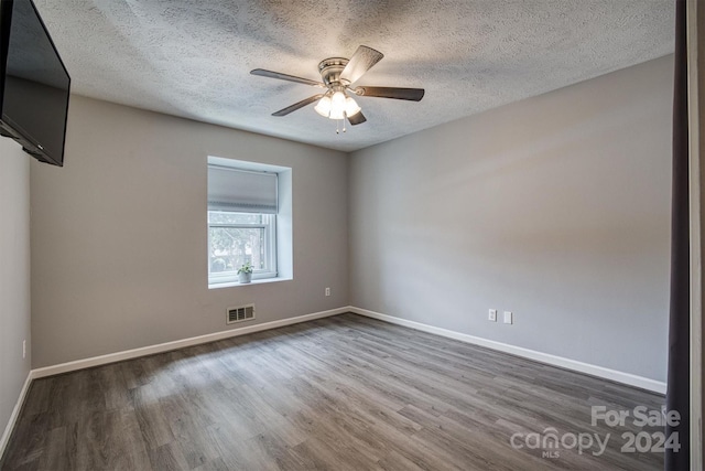 empty room featuring ceiling fan, a textured ceiling, and hardwood / wood-style flooring