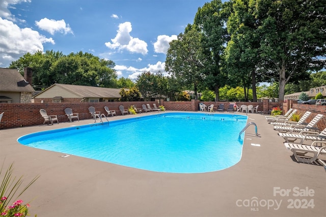 view of swimming pool featuring a patio area