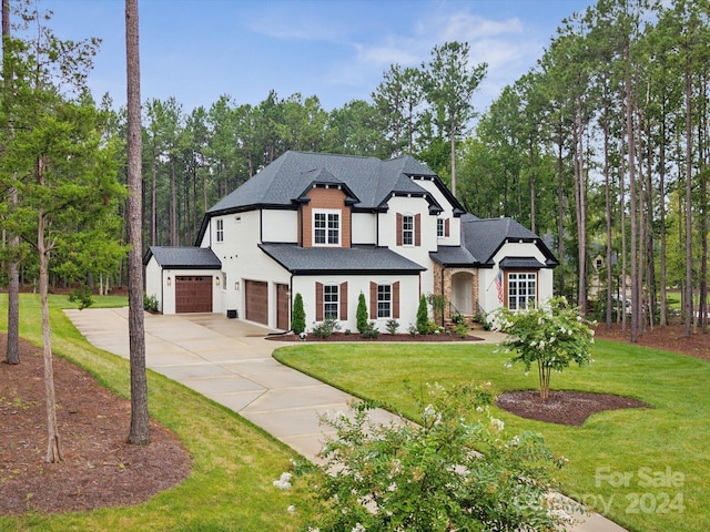 view of front of property featuring a garage and a front lawn