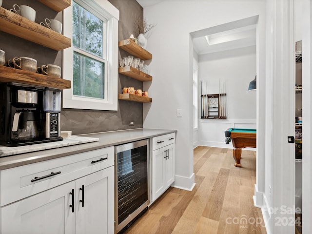 bar featuring wine cooler, white cabinetry, pool table, light wood-type flooring, and backsplash