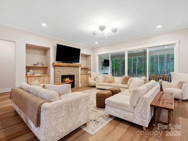 living room with hardwood / wood-style floors, a fireplace, and ornamental molding