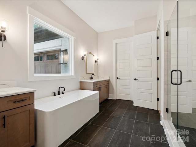 bathroom featuring vanity, independent shower and bath, and tile patterned flooring