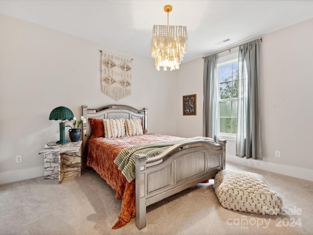 bedroom with an inviting chandelier and light colored carpet