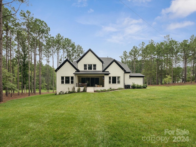 rear view of house with a lawn