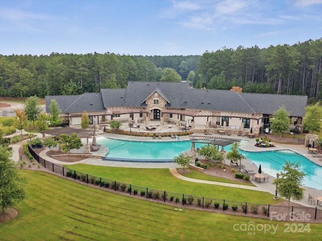 view of swimming pool with a patio and a lawn