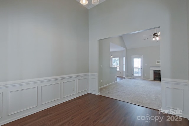 unfurnished room featuring lofted ceiling, ceiling fan, and dark hardwood / wood-style floors