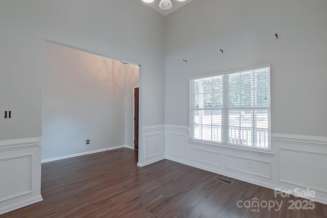 unfurnished room featuring dark hardwood / wood-style floors