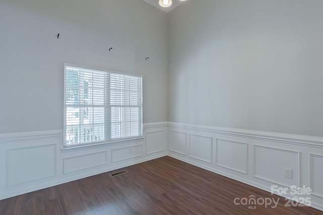 unfurnished room with dark hardwood / wood-style floors