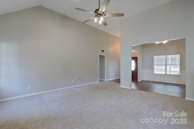 spare room featuring high vaulted ceiling, light colored carpet, and ceiling fan