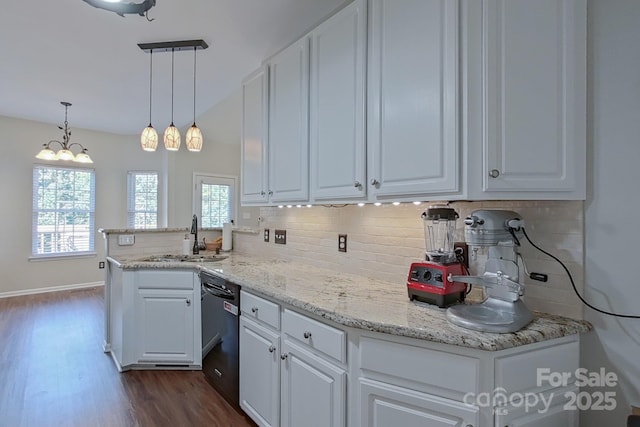 kitchen with black dishwasher, white cabinets, decorative light fixtures, and sink