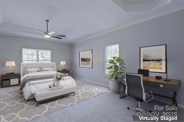 bedroom with ceiling fan, ornamental molding, light colored carpet, and a raised ceiling