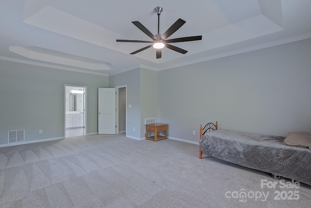 unfurnished bedroom with light carpet, ceiling fan, crown molding, and a tray ceiling