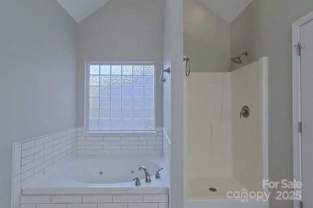 bathroom featuring lofted ceiling and independent shower and bath