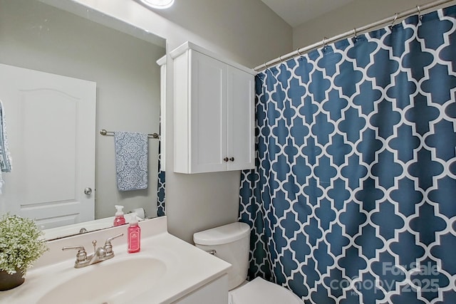 bathroom featuring toilet and vanity