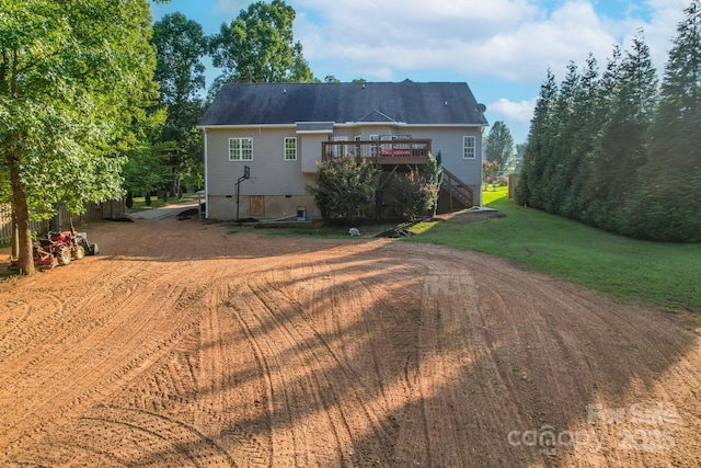 back of house featuring a wooden deck