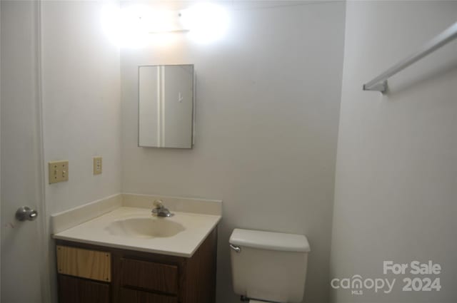 bathroom featuring toilet and vanity