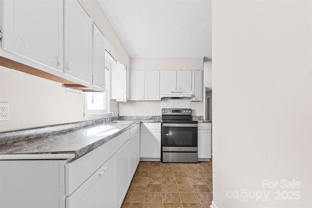 kitchen with stainless steel electric stove, sink, white cabinets, and a textured ceiling