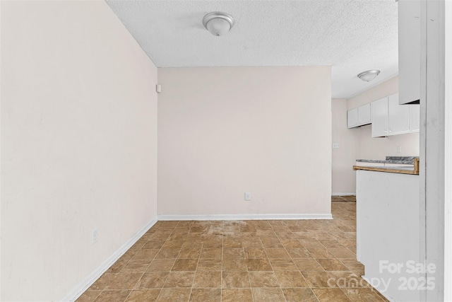 unfurnished room featuring a textured ceiling