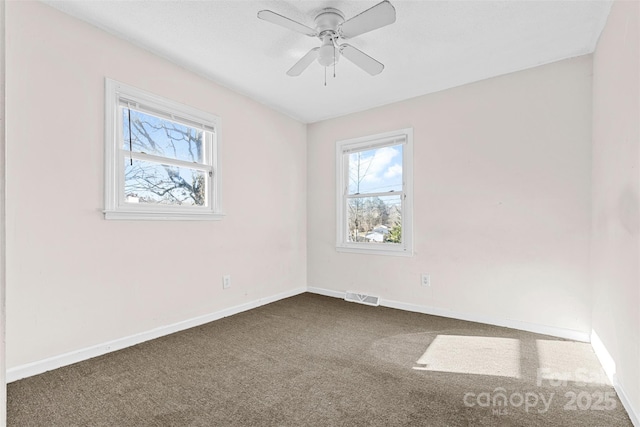 empty room featuring carpet floors and ceiling fan