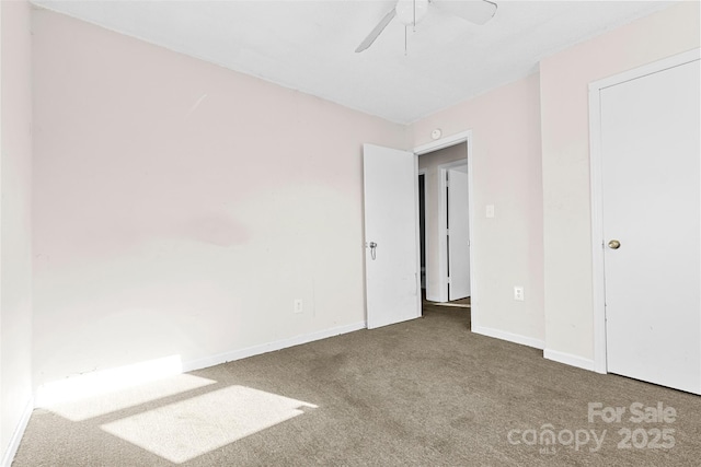 unfurnished room featuring ceiling fan and carpet floors