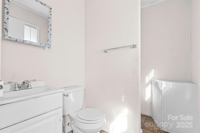 bathroom featuring tile patterned floors, vanity, and toilet