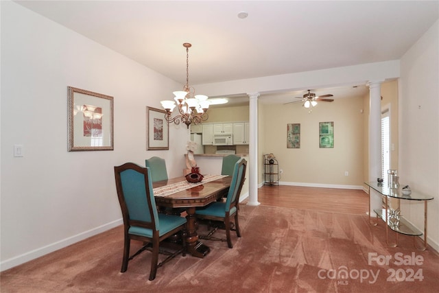 carpeted dining space with ceiling fan with notable chandelier and decorative columns