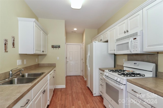 kitchen with light wood-type flooring, sink, white appliances, and white cabinets