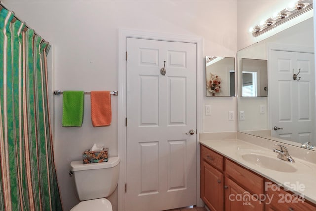 bathroom featuring toilet and vanity