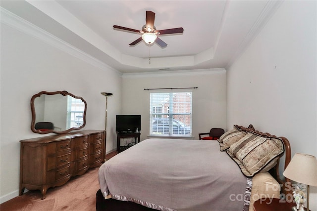 carpeted bedroom featuring ceiling fan, a raised ceiling, and crown molding