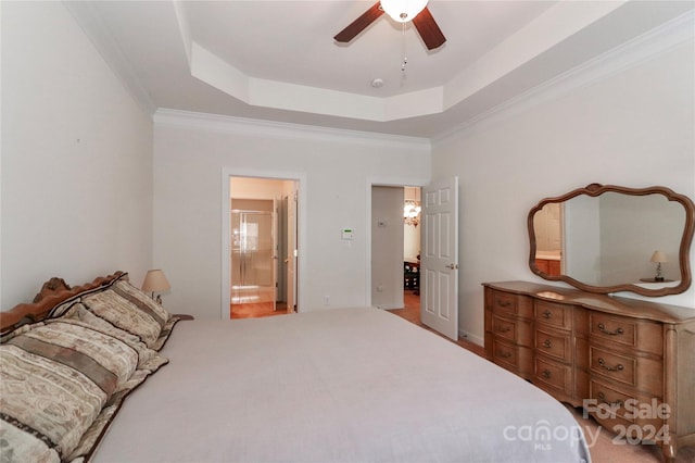 bedroom with ceiling fan, a raised ceiling, connected bathroom, and ornamental molding