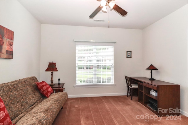 living room with carpet floors, ceiling fan, and a healthy amount of sunlight