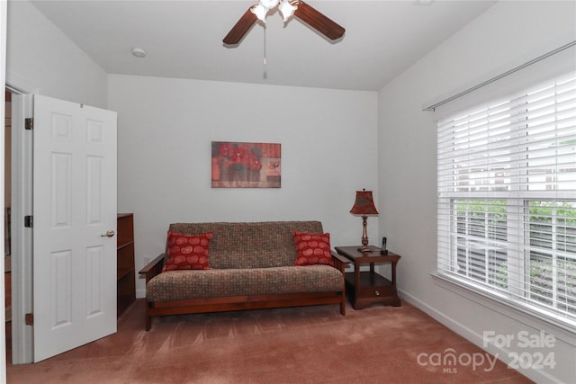 living area featuring carpet floors and ceiling fan