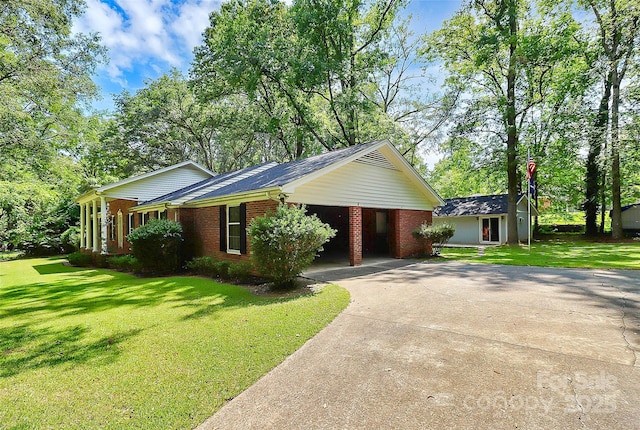 ranch-style house featuring a front yard and a carport